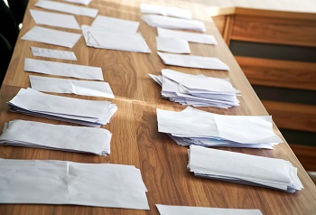 Sheets of paper collected during a poll, referendum, questionnaire or election, with the wishes of citizens, are on the table systematized and ready to be counted. Democracy in action.