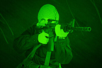 East Islamic rebel with assault rifle. View through night vision scope.