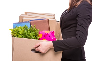 Side view. Business woman holding box with office items. isolated on white background.